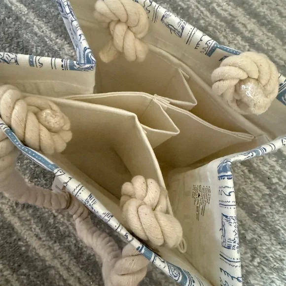 The item is a canvas wine bag by Tommy Bahama, designed to hold four bottles. - Picture 3 of 5